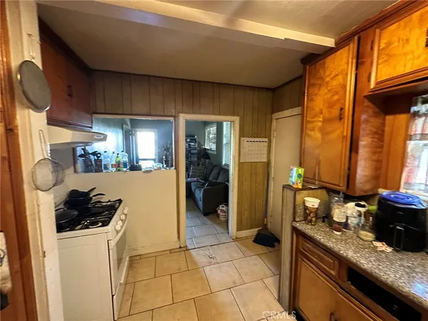a kitchen with stainless steel appliances granite countertop a sink and a refrigerator