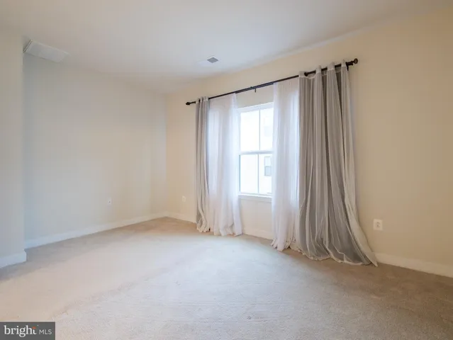 an empty room with a empty space and a window