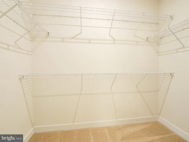 a view of a livingroom with workspace and a window