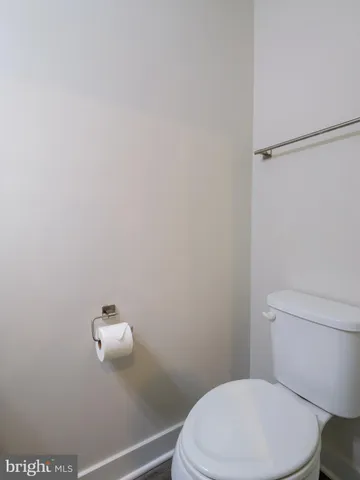 a white toilet sitting next to a bathroom sink