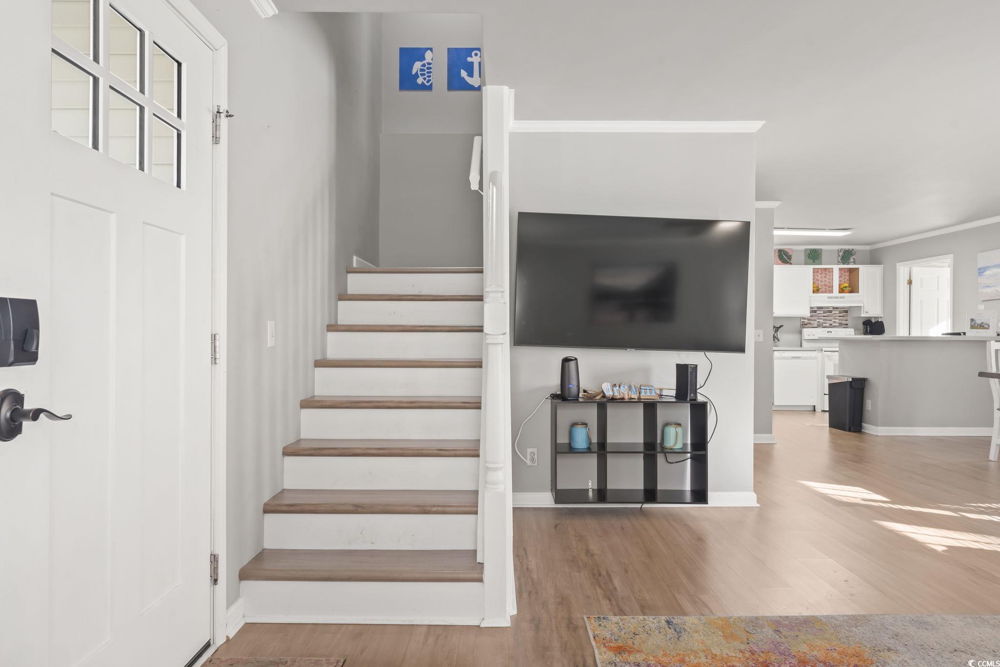 409 Knoll Court Myrtle Beach, SC 29588 - Photo 11 of 33 Stairway with wood finished floors and ornamental molding