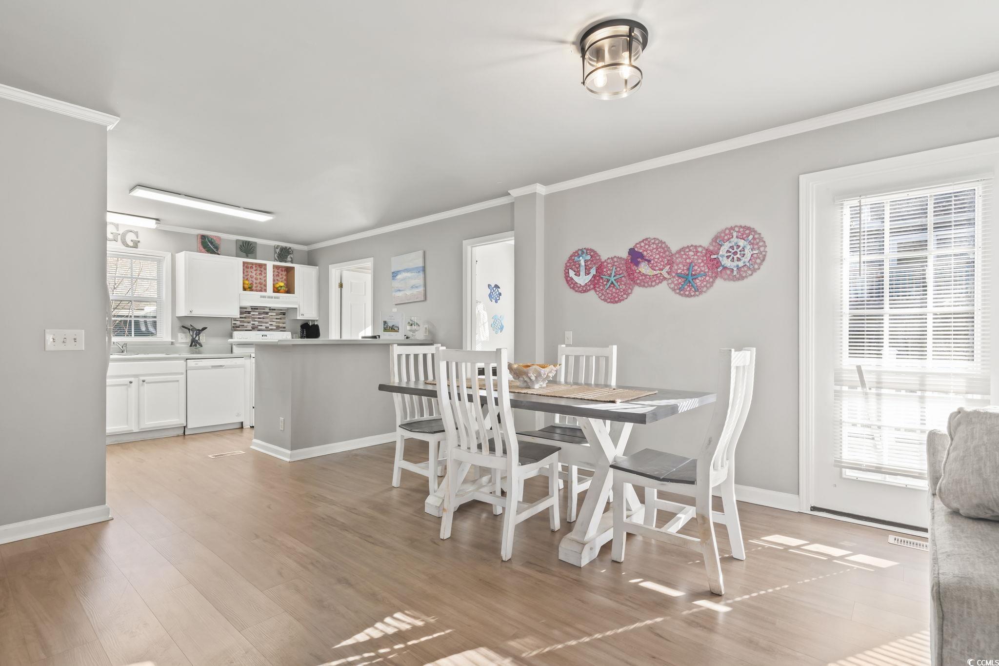 409 Knoll Court Myrtle Beach, SC 29588 - Photo 14 of 33 Dining area with light wood finished floors and crown molding