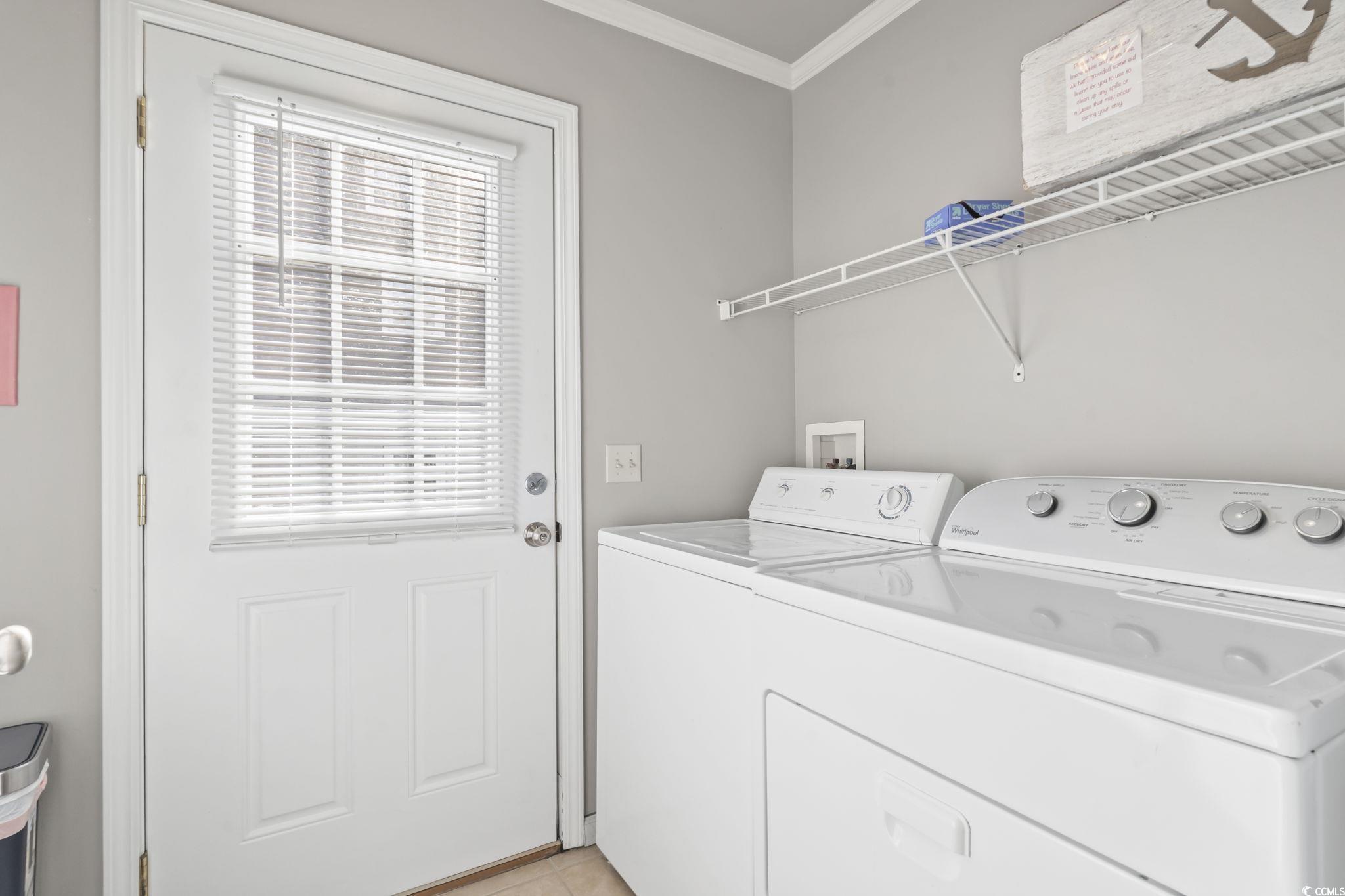 409 Knoll Court Myrtle Beach, SC 29588 - Photo 16 of 33 Laundry area featuring healthy amount of natural light, ornamental molding, washing machine and dryer, and light tile patterned floors