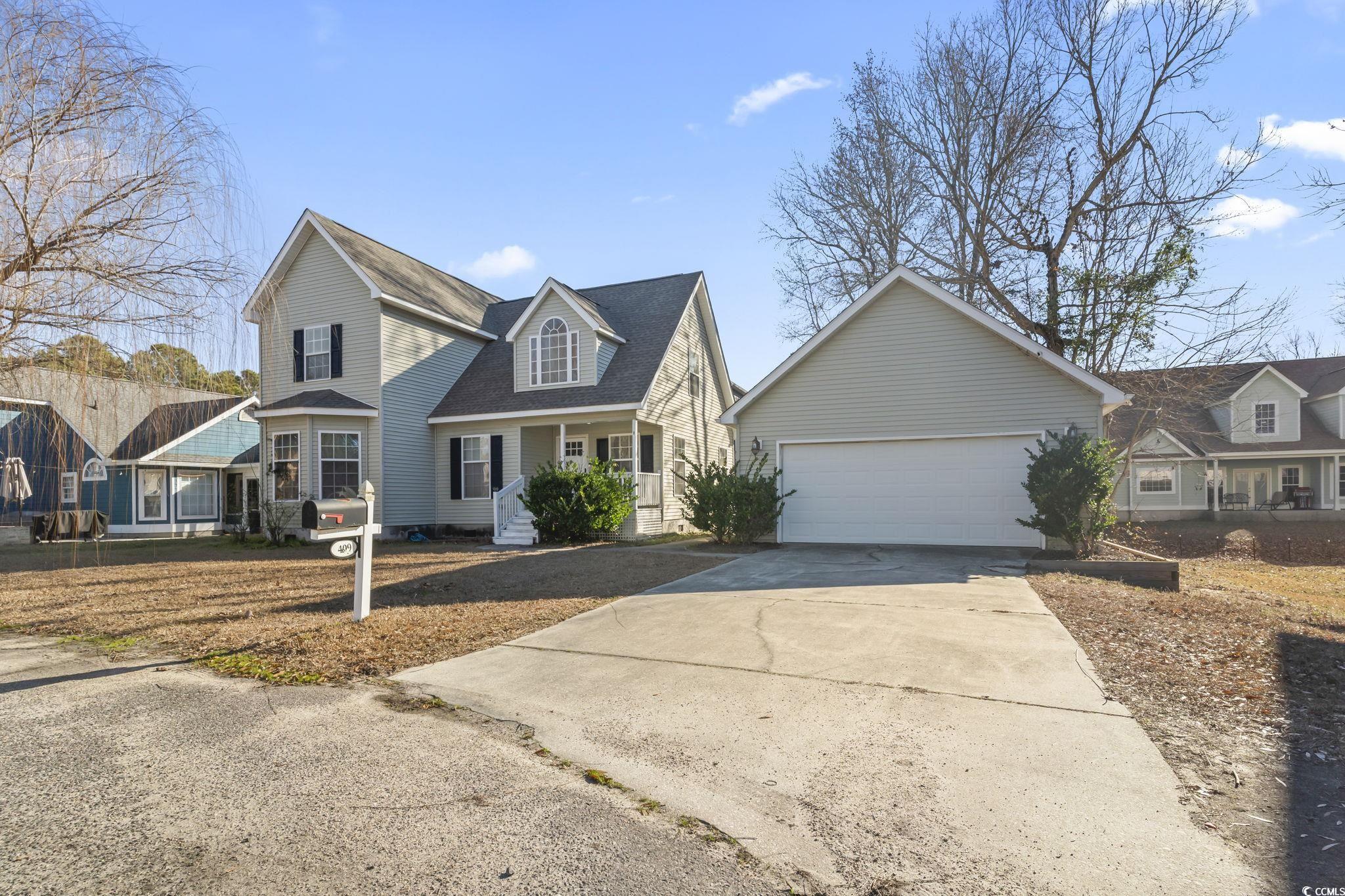 409 Knoll Court Myrtle Beach, SC 29588 - Photo 2 of 33 View of front of property featuring covered porch, concrete driveway, roof with shingles, and an attached garage