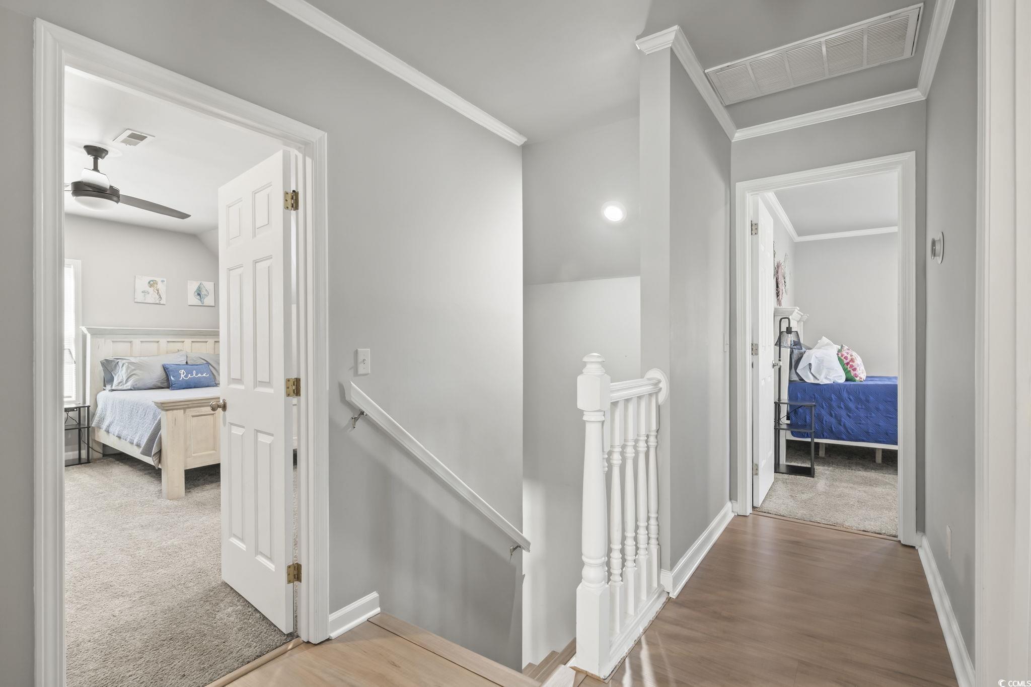 409 Knoll Court Myrtle Beach, SC 29588 - Photo 21 of 33 Corridor with an upstairs landing, crown molding, and light colored carpet