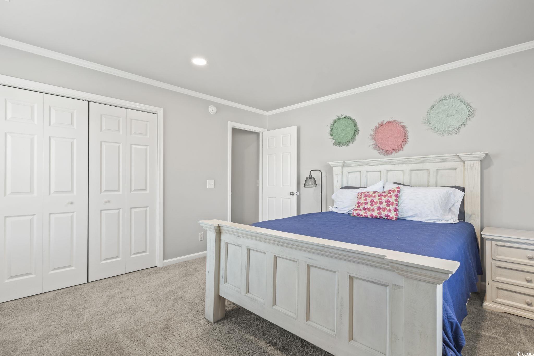 409 Knoll Court Myrtle Beach, SC 29588 - Photo 27 of 33 Bedroom featuring carpet, ornamental molding, and a closet