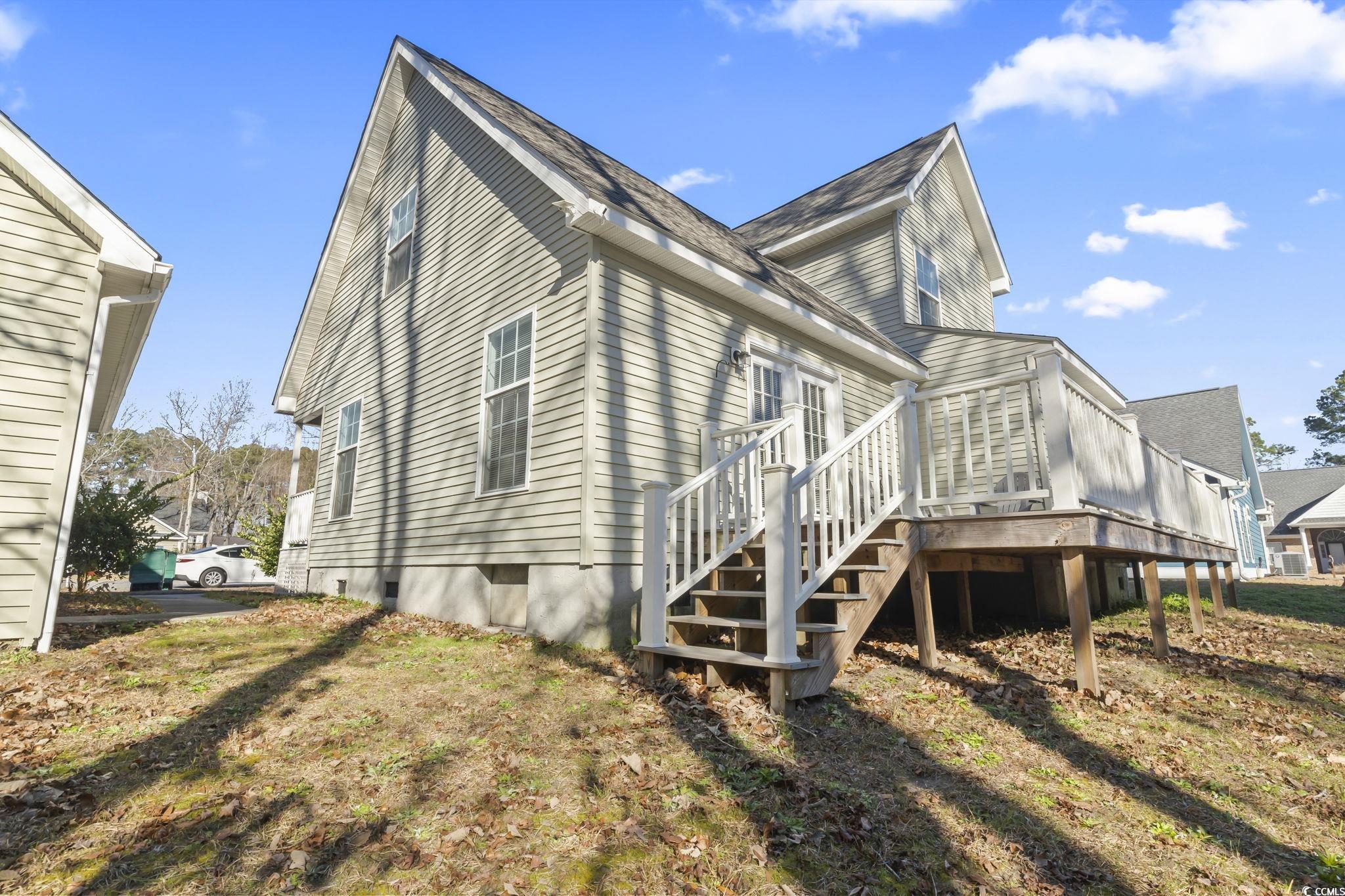 409 Knoll Court Myrtle Beach, SC 29588 - Photo 28 of 33 Rear view of property featuring a yard and stairway