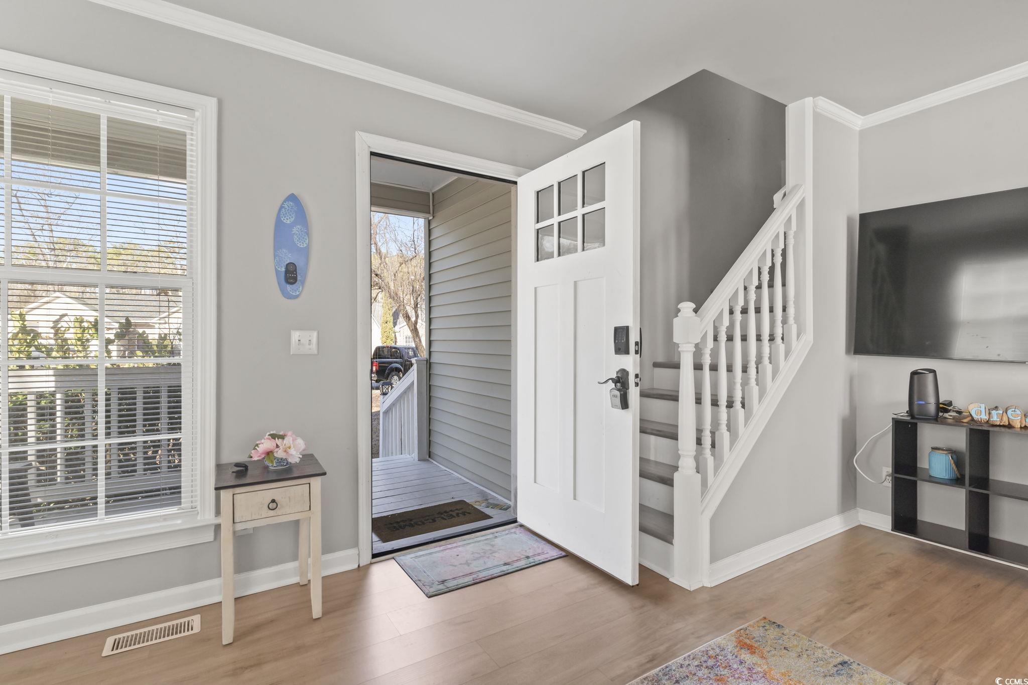 409 Knoll Court Myrtle Beach, SC 29588 - Photo 6 of 33 Entryway with light wood-style floors, crown molding, and stairway