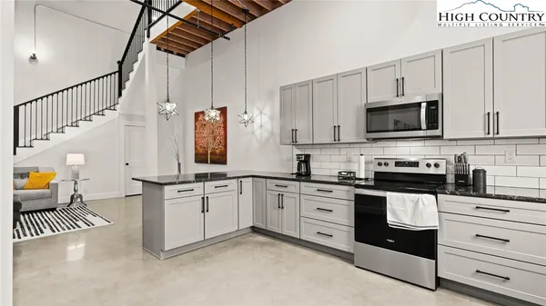a kitchen with appliances a sink and cabinets