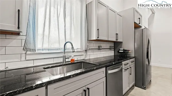 a kitchen with stainless steel appliances a sink and cabinets