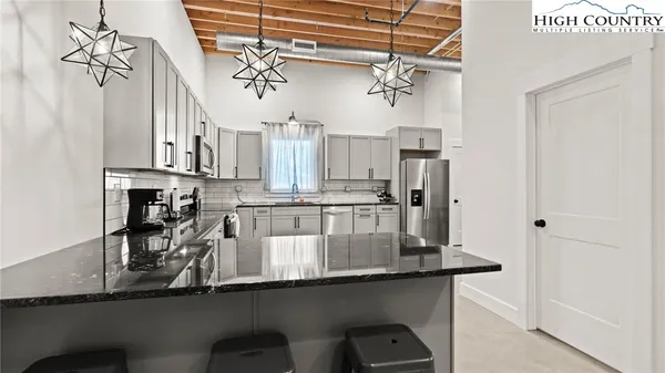 a kitchen with stainless steel appliances a sink cabinets and a counter top space