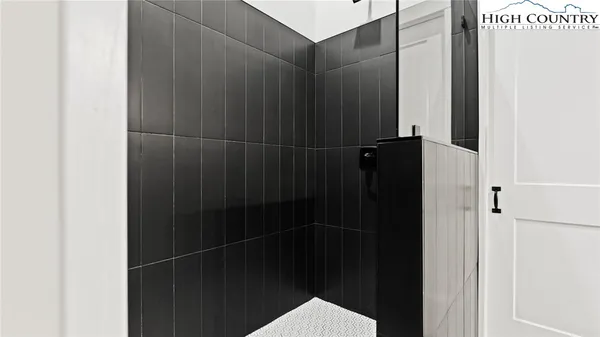 a bathroom with a shower and a glass door