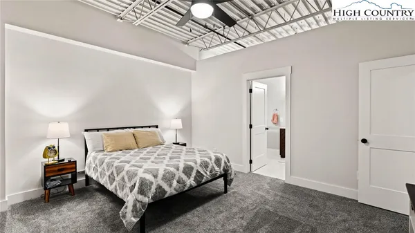 a bedroom with two beds and a chandelier
