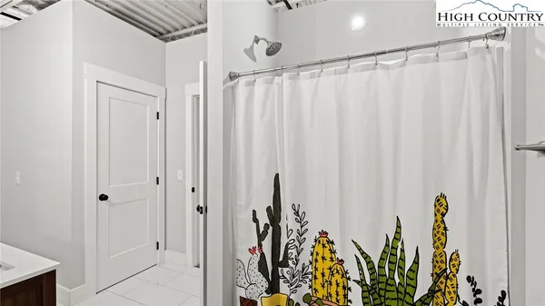 a bathroom with a sink a mirror and shower