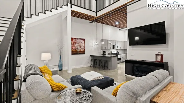 a balcony with furniture and a kitchen view