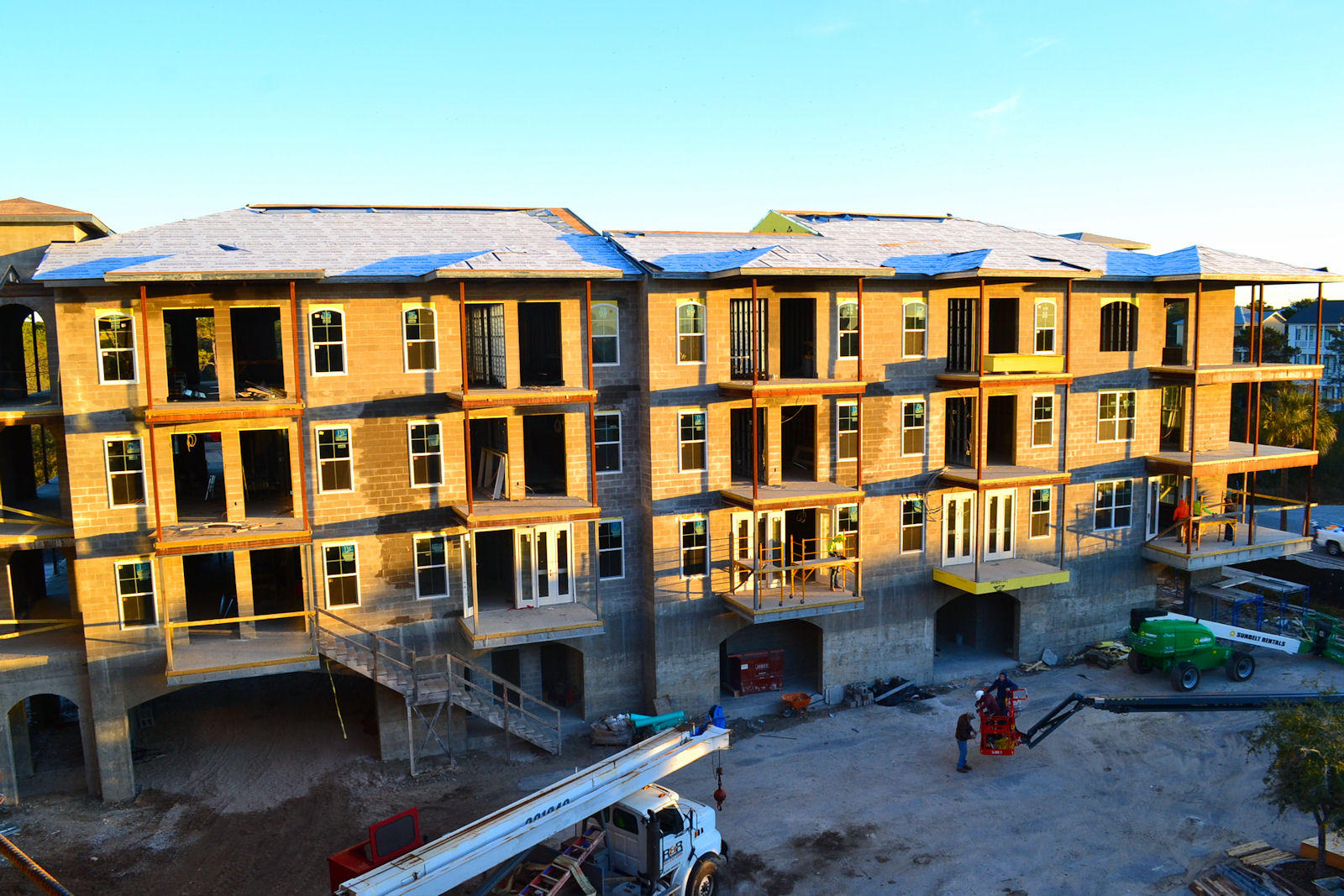 a front view of a residential apartment building with a yard