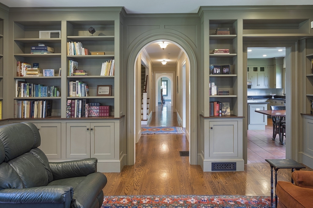 49 Willard Common Concord, MA 01742 - Photo 13 of 39 a living room with furniture and a book shelf
