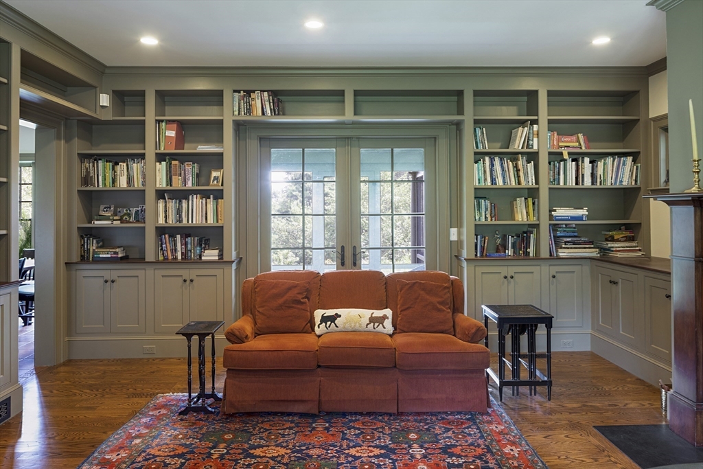 49 Willard Common Concord, MA 01742 - Photo 14 of 39 a living room with furniture a rug and a book shelf