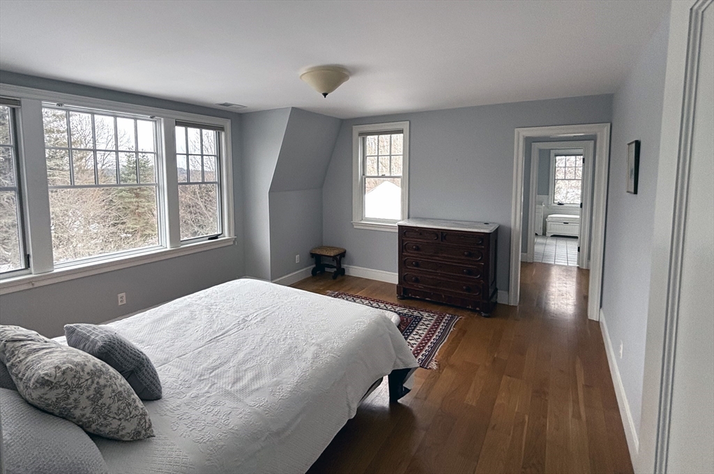 49 Willard Common Concord, MA 01742 - Photo 22 of 39 a bedroom with a bed and wooden floor