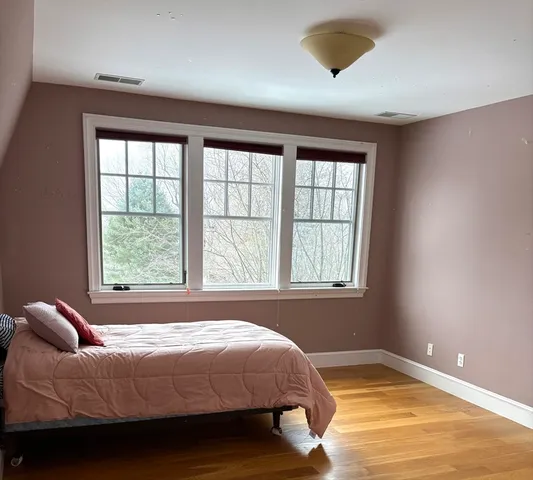 a bedroom with a bed and window