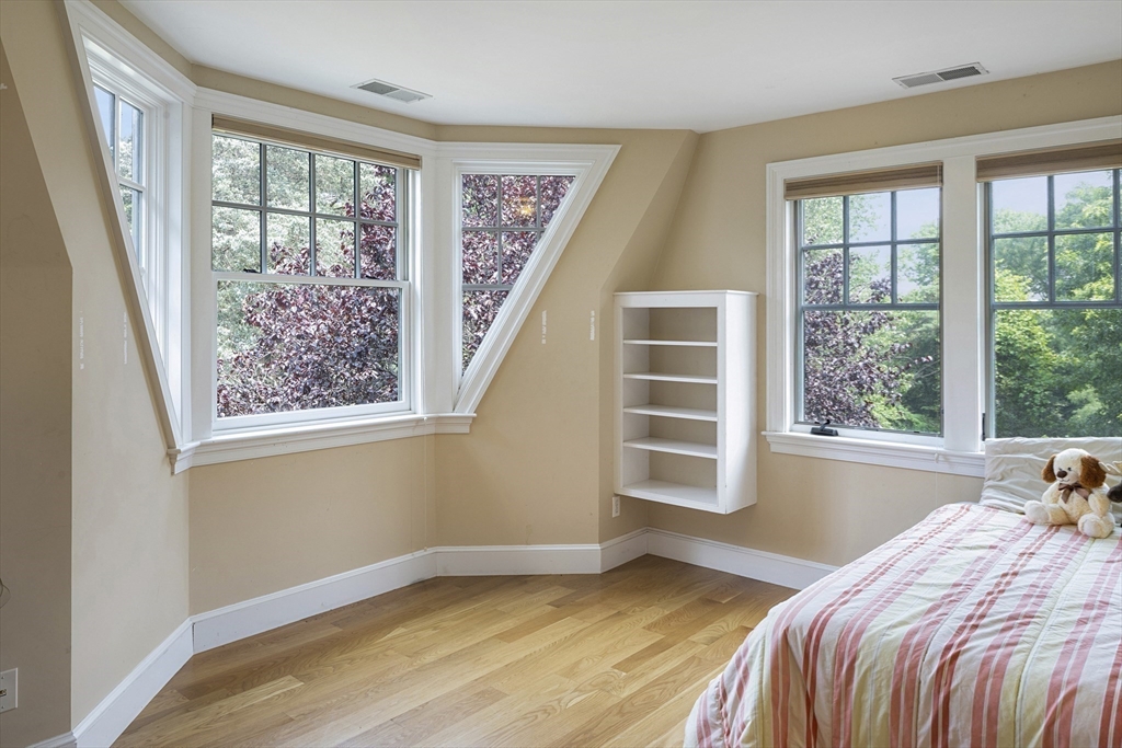 49 Willard Common Concord, MA 01742 - Photo 27 of 39 a bedroom with a bed and wooden floor