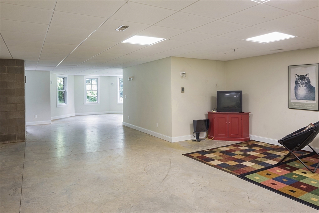 49 Willard Common Concord, MA 01742 - Photo 31 of 39 a living room with furniture rug and window