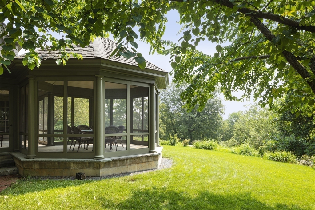 49 Willard Common Concord, MA 01742 - Photo 32 of 39 a view of backyard with a barn and large trees