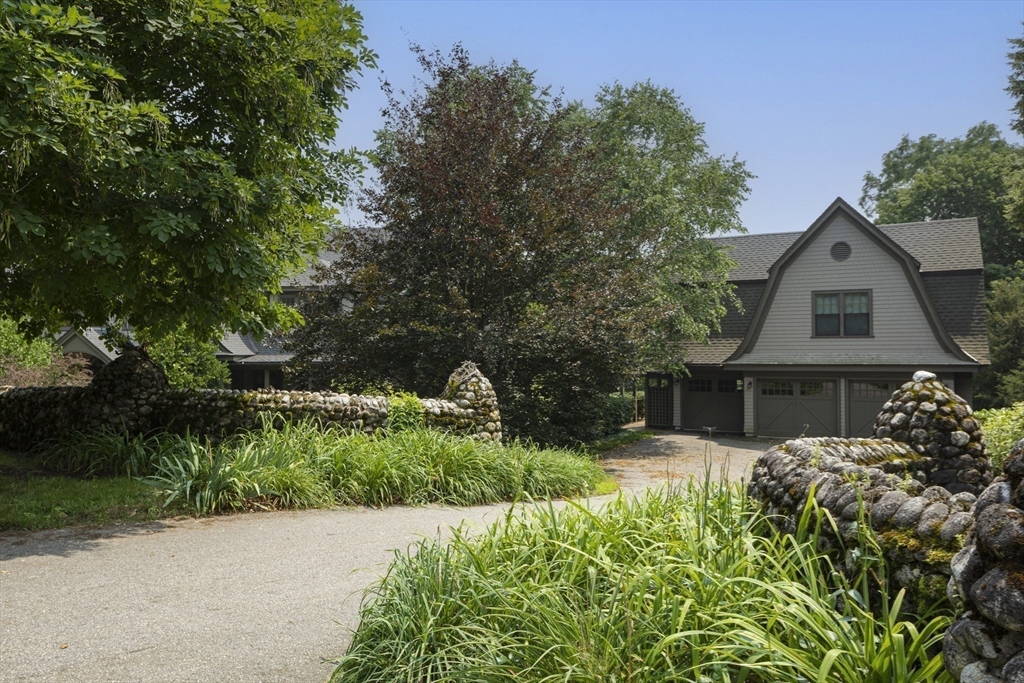 49 Willard Common Concord, MA 01742 - Photo 35 of 39 a front view of a house with a yard and potted plants