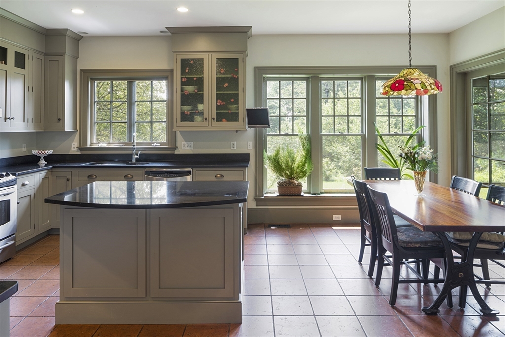 49 Willard Common Concord, MA 01742 - Photo 9 of 39 a kitchen with granite countertop a stove a sink and a microwave