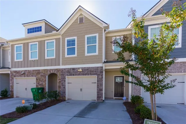 a front view of a house with a yard