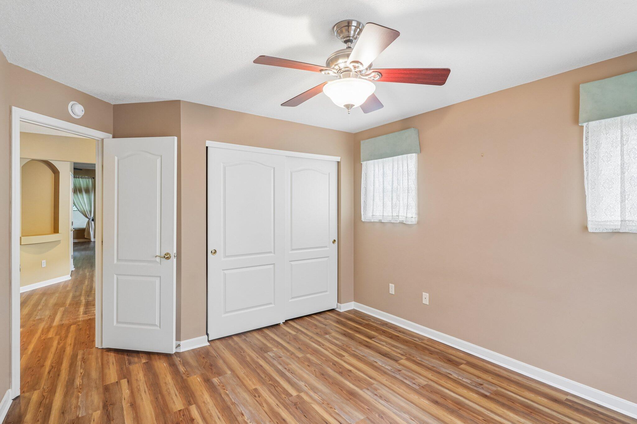876 Flint Ridge Newport, KY 41076 - Photo 32 of 43 Interior room featuring wood-finish flooring, two panel doors, a ceiling fan with light fixture, and two windows