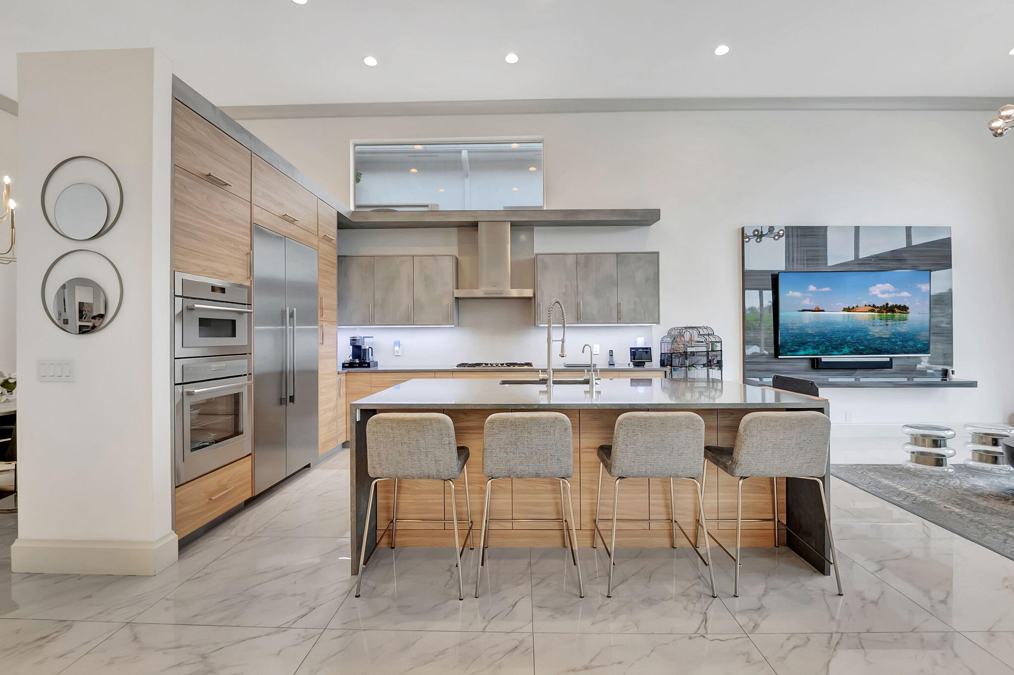 a large white kitchen with a white stove a table and chairs