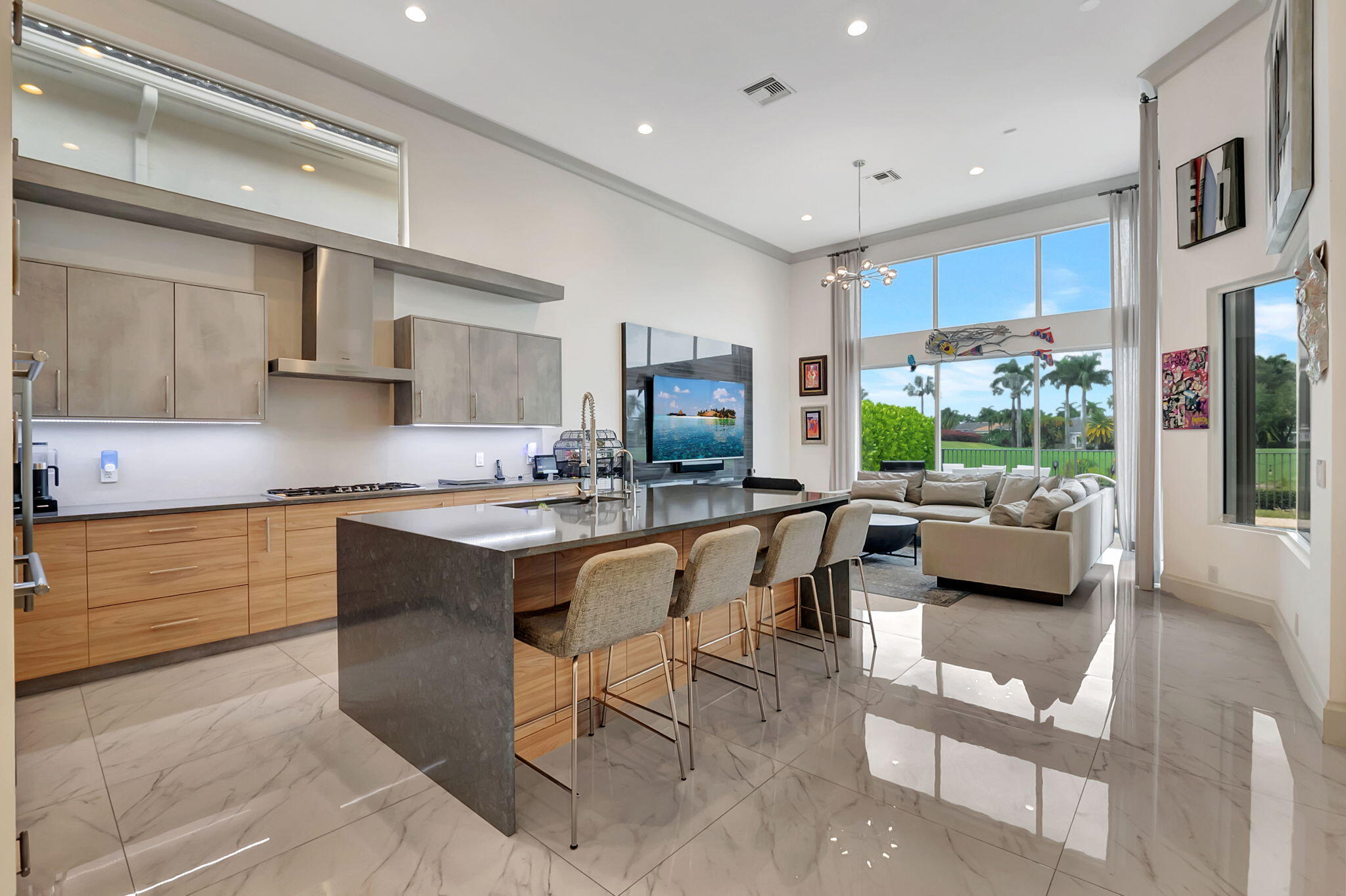 4137 Briarcliff Circle Boca Raton, FL 33496 - Photo 14 of 59 a kitchen with stainless steel appliances kitchen island granite countertop a couch and a view of living room
