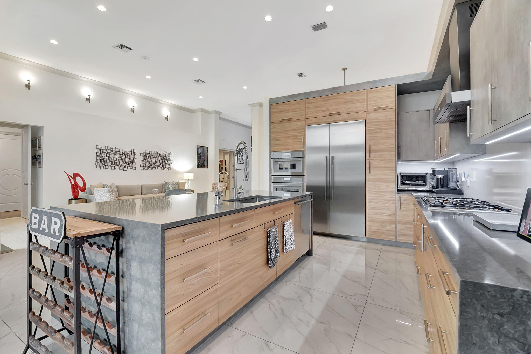 4137 Briarcliff Circle Boca Raton, FL 33496 - Photo 16 of 59 a kitchen with stainless steel appliances granite countertop a sink and a refrigerator