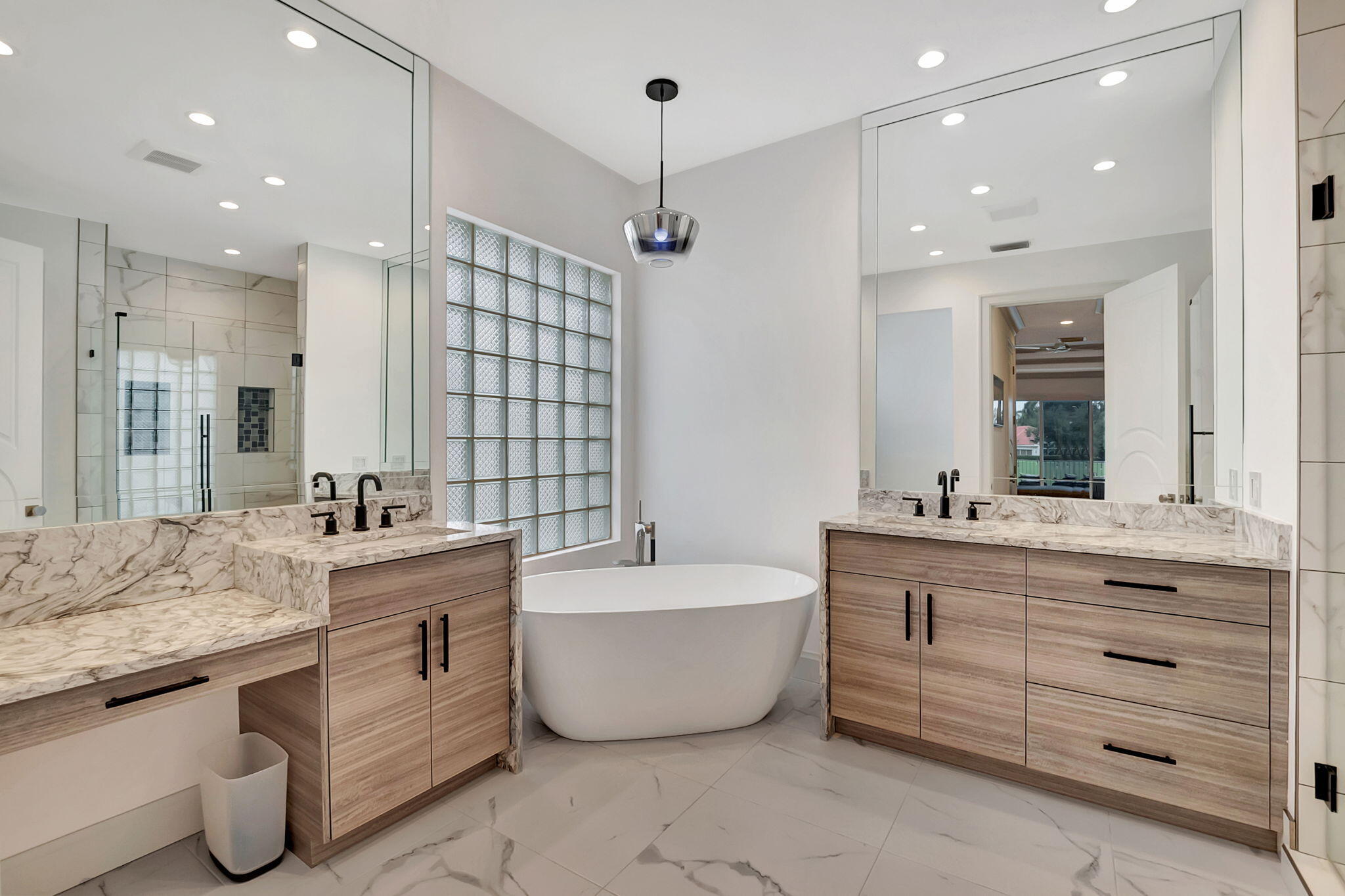 4137 Briarcliff Circle Boca Raton, FL 33496 - Photo 20 of 59 a bathroom with a tub a double vanity sink a mirror and a shower