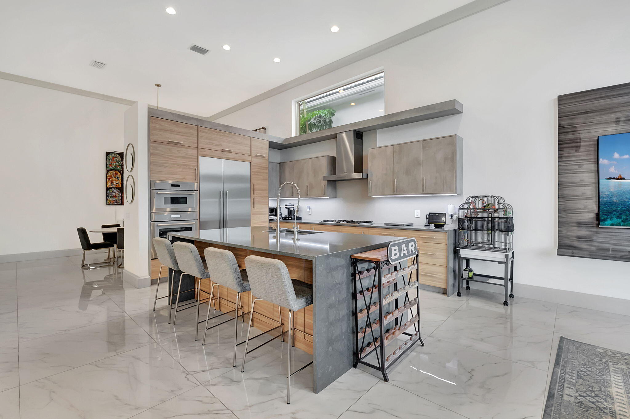 4137 Briarcliff Circle Boca Raton, FL 33496 - Photo 2 of 59 a kitchen with stainless steel appliances granite countertop a table chairs sink and cabinets
