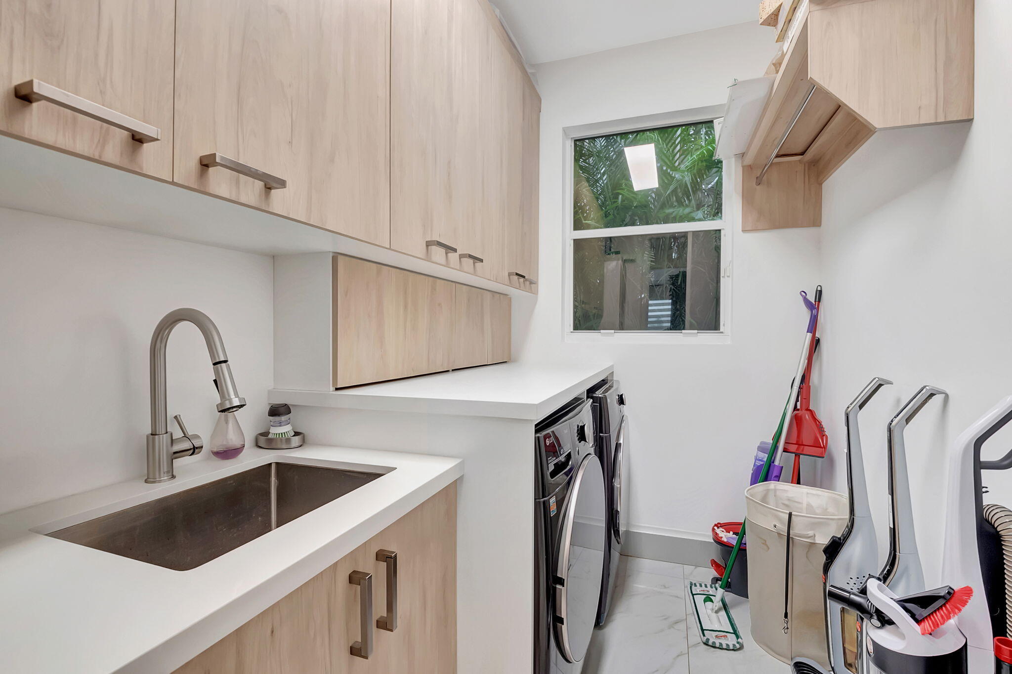 4137 Briarcliff Circle Boca Raton, FL 33496 - Photo 25 of 59 a kitchen with a sink a refrigerator and cabinets