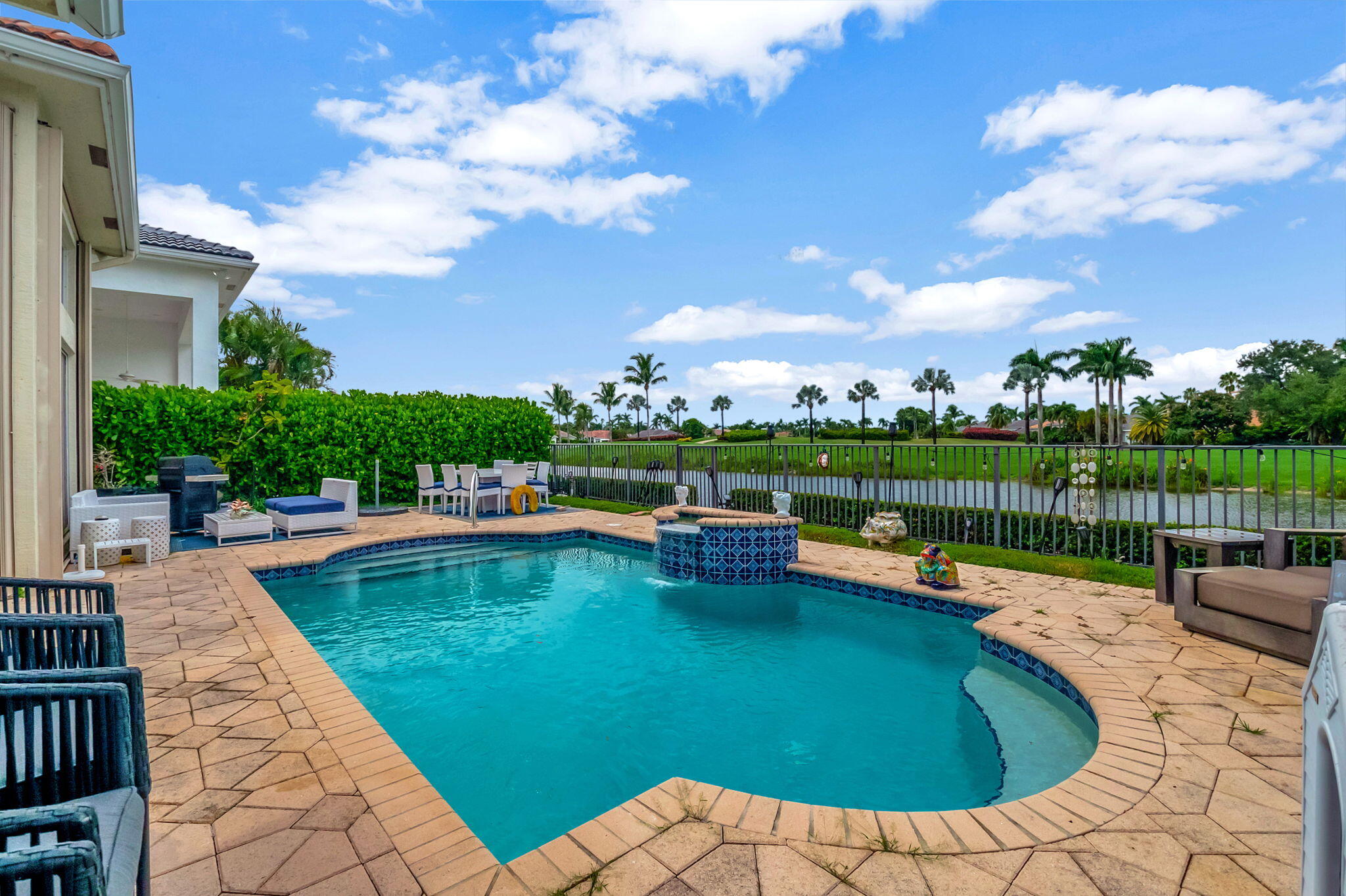 4137 Briarcliff Circle Boca Raton, FL 33496 - Photo 29 of 59 a view of a swimming pool with a patio and a garden