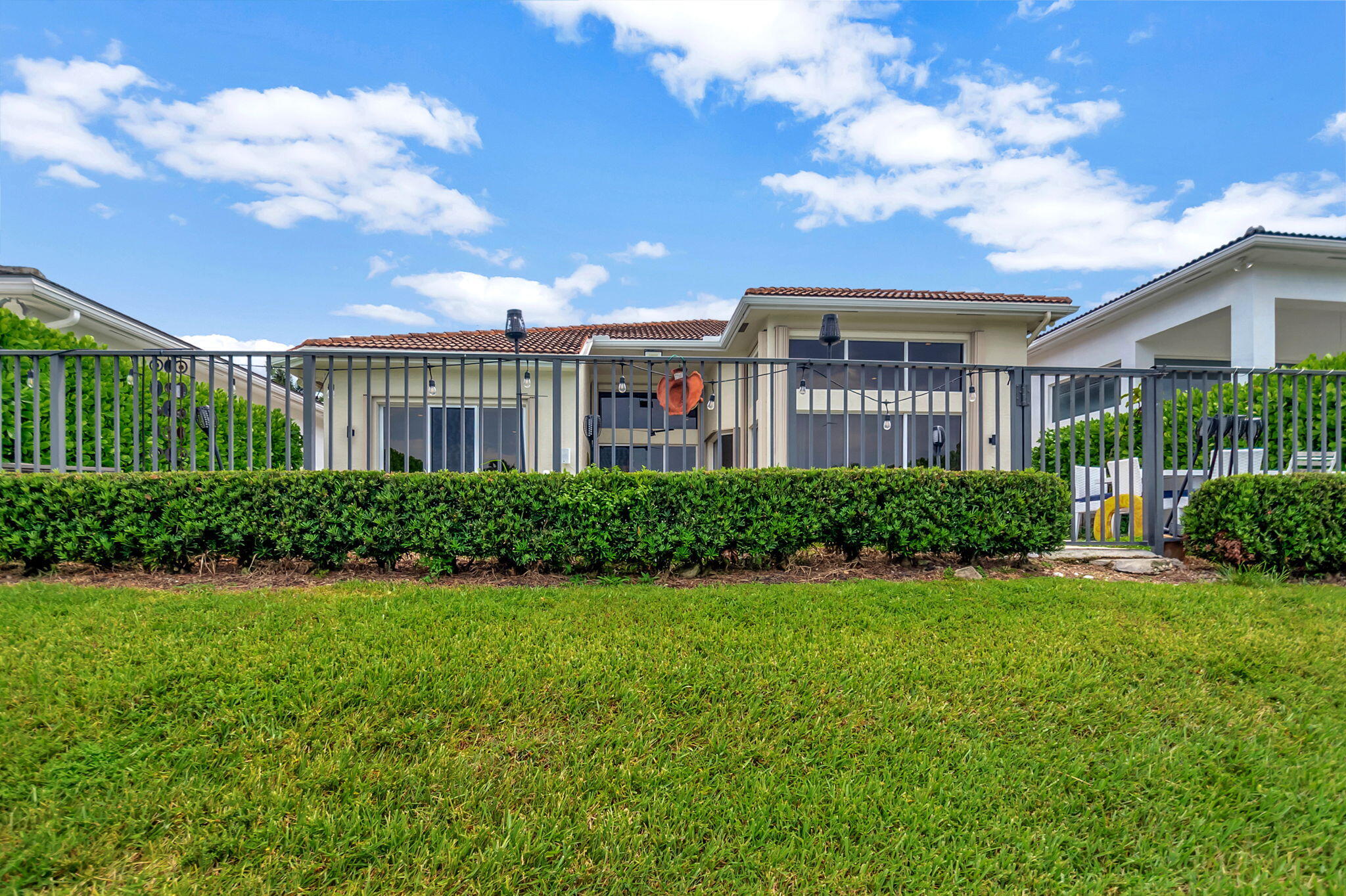 4137 Briarcliff Circle Boca Raton, FL 33496 - Photo 30 of 59 a front view of a house with a yard