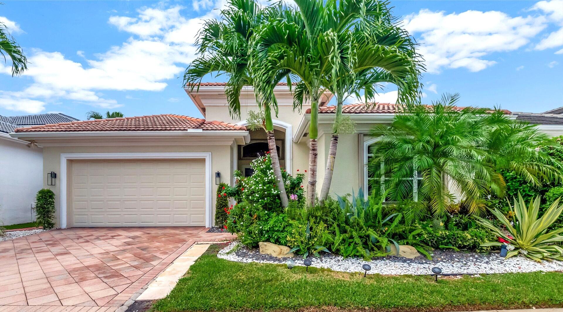 4137 Briarcliff Circle Boca Raton, FL 33496 - Photo 3 of 59 a front view of a house with a garden and plants
