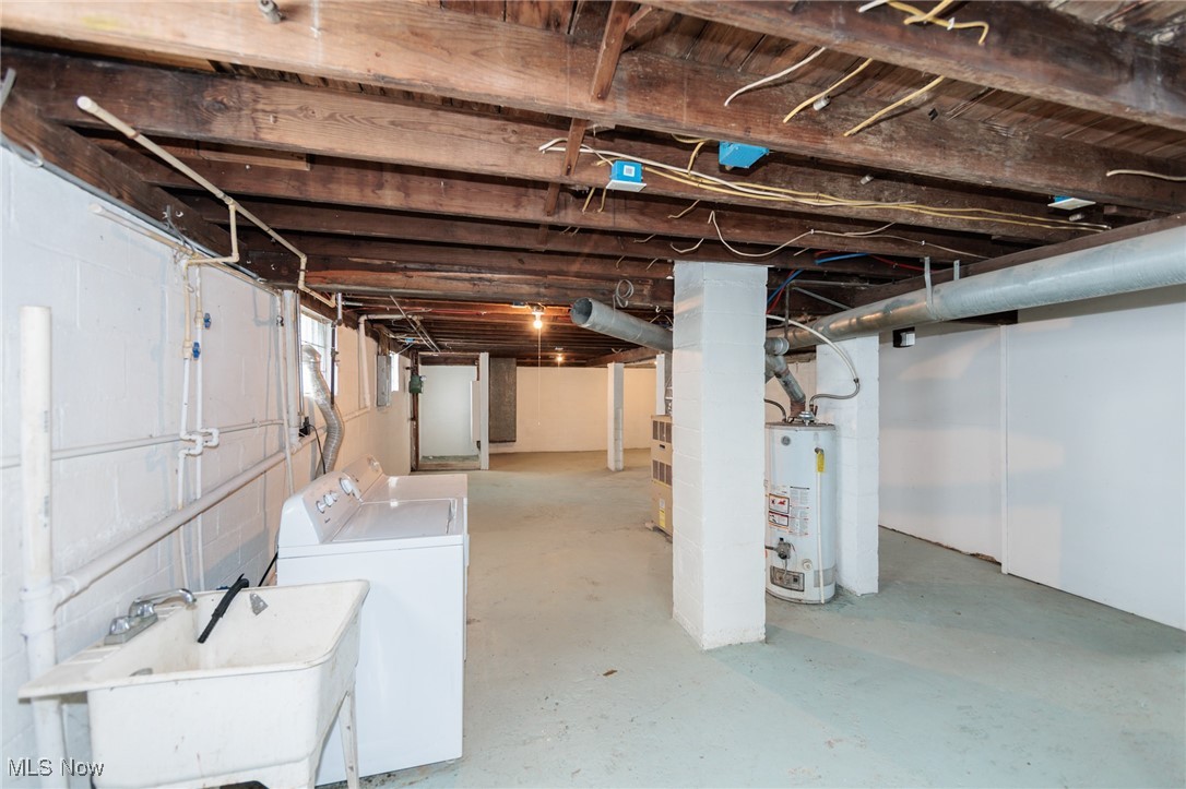 5062 Lee Road Maple Heights, OH 44137 - Photo 26 of 50 Unfinished below grade area with gas water heater and separate washer and dryer