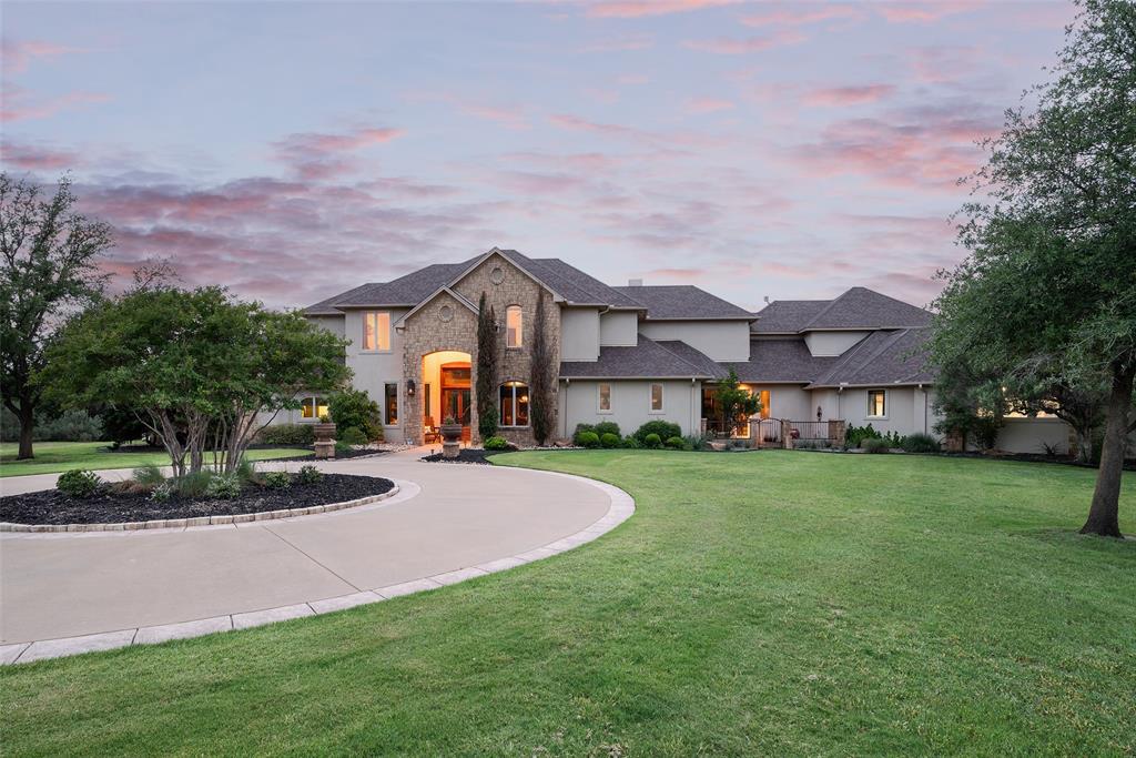2312 Cactus Rio Lane Weatherford, TX 76087 - Photo 1 of 37 a view of a big house with a big yard and large trees