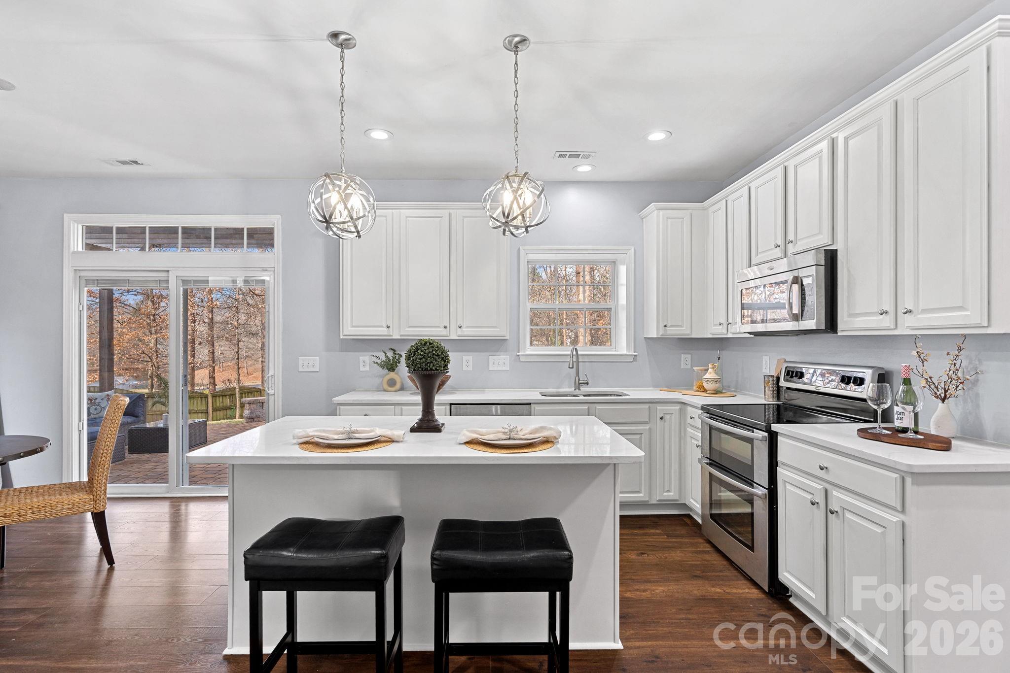 2017 East Foxwood Court Fort Mill, SC 29707 - Photo 9 of 33 a kitchen with sink dining table and chairs