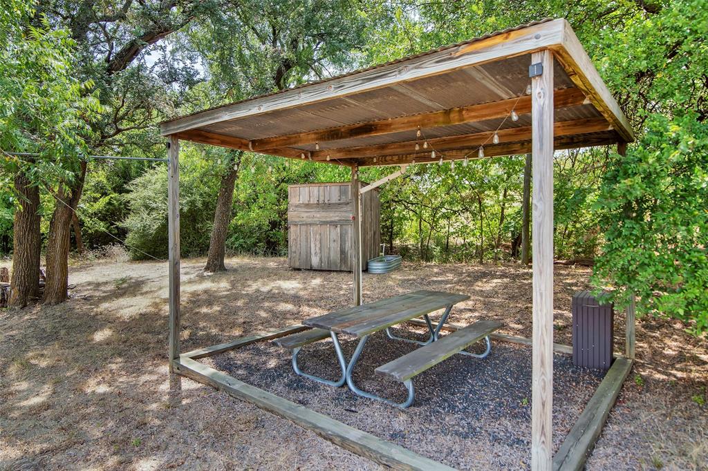 10616 Highway 78 Blue Ridge, TX 75424 - Photo 28 of 28 a view of a patio with table and chairs under an umbrella