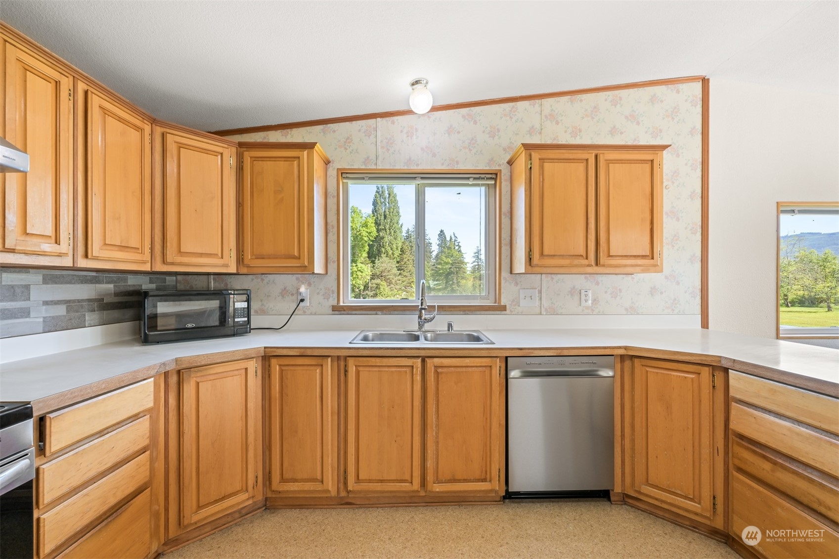 3323 East Smith Road Bellingham, WA 98226 - Photo 11 of 34 a kitchen with sink cabinets and window