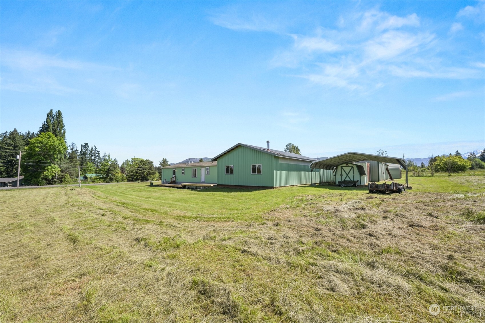 3323 East Smith Road Bellingham, WA 98226 - Photo 30 of 34 a view of a big house with a big yard and large tree