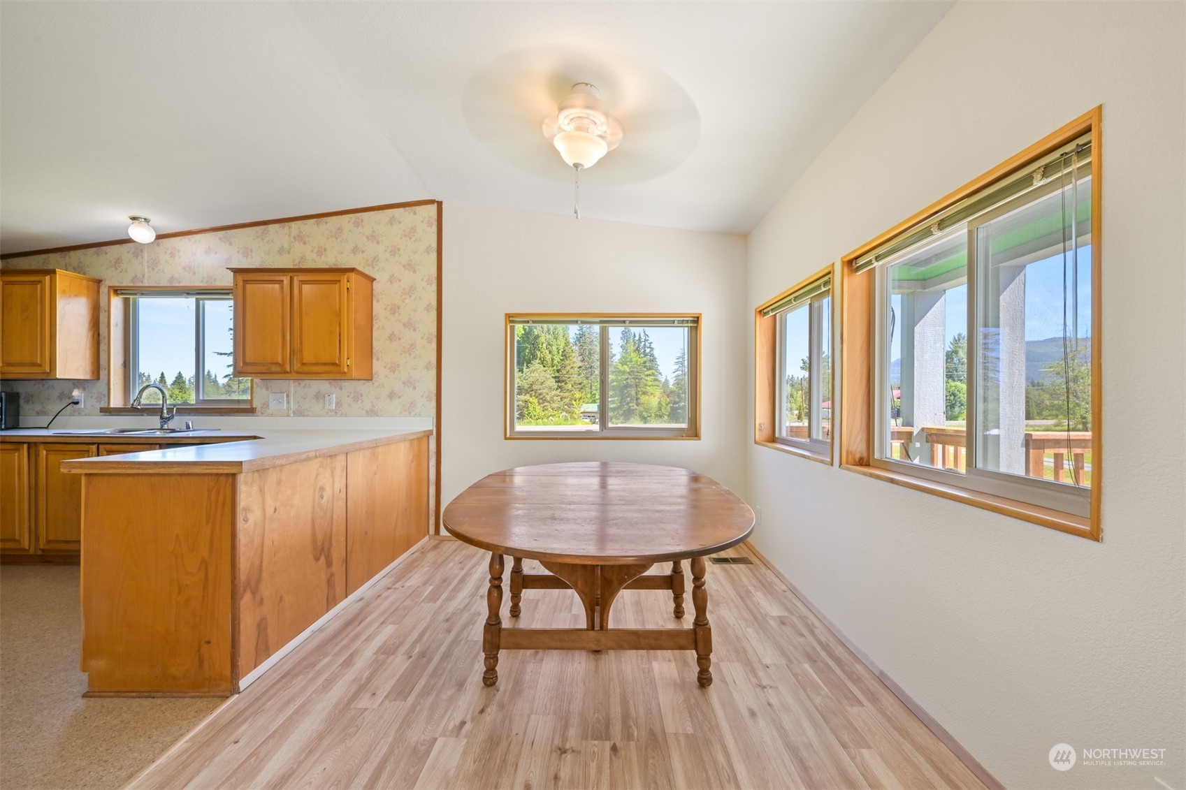 3323 East Smith Road Bellingham, WA 98226 - Photo 7 of 34 a view of a kitchen area with furniture and wooden floor