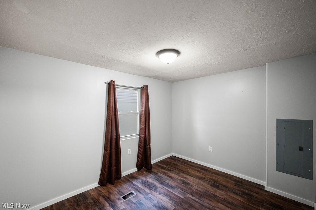 58 Rock Ridge Road Mineral Wells, WV 26150 - Photo 12 of 38 Wood-finish flooring, single window with blinds, overhead flush mount lighting, and light grey wall paint
