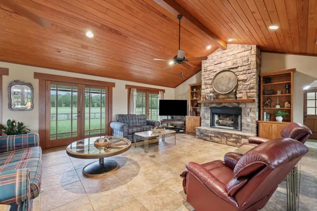 a living room with furniture a fireplace and a flat screen tv