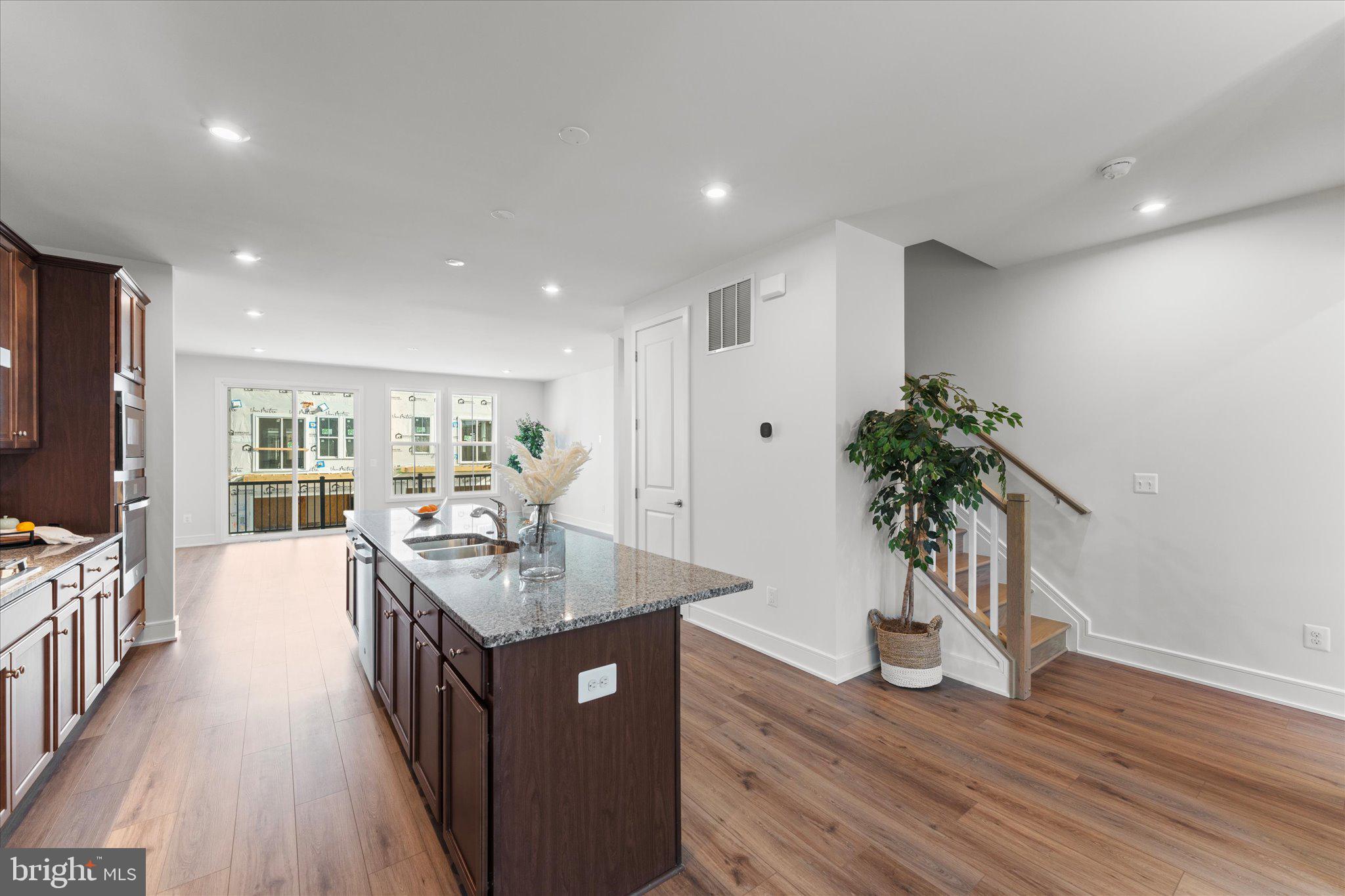 23080 Soaring Hts Terrace Ashburn, VA 20148 - Photo 11 of 44 a kitchen with counter top space and wooden floor